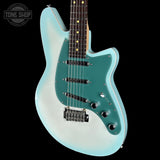 A light blue and white gradient electric guitar with a teal pickguard, black hardware, and a dark fretboard, shown against a solid black background with a Tone Shop watermark in the top-left corner.