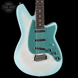 A Fender Stratocaster electric guitar with a light blue to white gradient finish, a turquoise pickguard, and a dark fretboard, shown against a solid black background with a Tone Shop watermark in the top left corner.