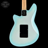 The back of an electric guitar with a light blue to white gradient finish, a natural wood neck, and black hardware, shown against a black background with a Tone Shop watermark in the top left.