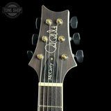 Guitar headstock with 'McCarty' branding on a black background