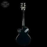 A glossy black double-cutaway electric guitar shown from the back against a solid black background, with a Tone Shop watermark in the upper left corner.