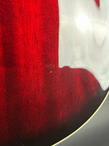 Close-up of a red textured surface with a white object partially visible.