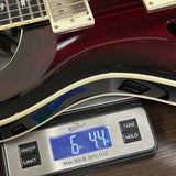 Guitar on a digital scale displaying weight