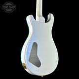 White electric guitar on a black background with 'Tone Shop' logo.