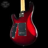 Close-up of the back of a red electric guitar with a black pickguard and maple neck, shown against a black background with a Tone Shop watermark in the top left.