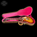 Gibson Les Paul guitar in a pink case with 'Tone Shop' logo.