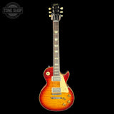 Electric guitar with a sunburst finish on a black background, featuring the Gibson logo.