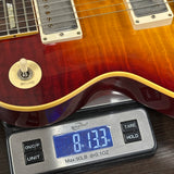 Used Gibson Les Paul on scale displaying weight.