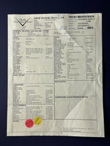 Sheet of paper with printed text and a red stamp on a dark background