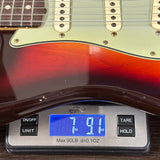 Guitar on a digital scale displaying weight