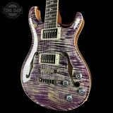 Purple electric guitar with a black background