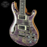 Purple electric guitar with a visible brand logo on a black background