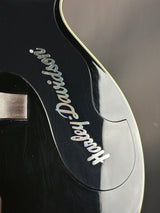 Close-up of a guitar headstock with 'Fender' branding on a black background