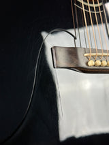 Close-up of an acoustic guitar's soundhole and bridge