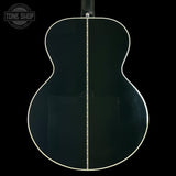 Back view of a black acoustic guitar with a visible brand logo in the corner.