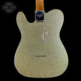 Back of a glittery green electric guitar with Fender logo on a black background