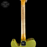Close-up of a green electric guitar with a black background