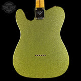 Green glittery guitar body with Fender logo on a black background