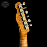 Guitar headstock with tuning pegs on a black background, featuring the Tone Shop logo.