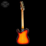Electric guitar with a sunburst finish on a black background, featuring the Tone Shop logo.