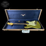 Green electric guitar in a blue case with Fender logo, Tone Shop branding.