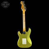 Green glitter electric guitar with a black background