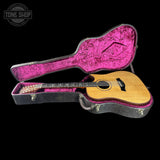 Acoustic guitar in a pink-lined case with 'Tone Shop' logo.