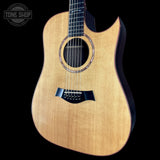 Acoustic guitar with a visible brand logo on a black background