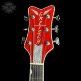 Red Gretsch guitar headstock on a black background
