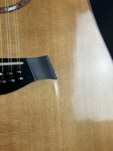 Close-up of a guitar's body with a focus on the soundhole and neck