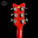 Red guitar headstock with tuning pegs on a black background, featuring 'Tone Shop' logo.