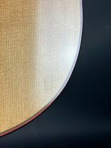 Close-up of a circular object with a gradient from white to beige on a dark background