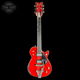 Red electric guitar with a black background