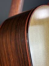 Close-up of a wooden guitar with a focus on the neck and body.
