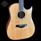 Acoustic guitar with a visible brand logo on a black background