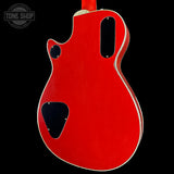 Red electric guitar body with 'Tone Shop' logo in the corner
