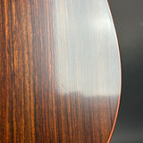 Close-up of a wooden surface with a dark brown and light brown striped pattern on a dark gray background.