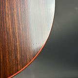 Close-up of a wooden surface with a dark brown and light brown pattern on a gray background