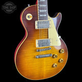 Electric guitar with a sunburst finish on a black background, featuring the Tone Shop logo.