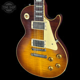 Electric guitar with a sunburst finish on a black background, featuring the Tone Shop logo.