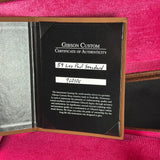 Gibson Custom Certificate of Authenticity for a 59 Les Paul Standard guitar on a pink background