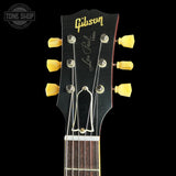 Gibson Les Paul guitar headstock with tuning pegs on a black background