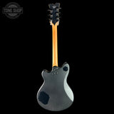 Guitar with a black finish and wooden neck on a white background