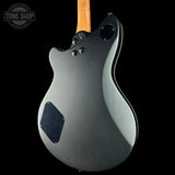 Guitar body with a wooden neck on a black background, featuring the Tone Shop logo.