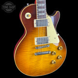 Electric guitar with a sunburst finish on a black background, featuring the Tone Shop logo.
