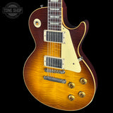 Electric guitar with a sunburst finish on a black background, featuring the Tone Shop logo.