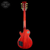 Red electric guitar on a black background with 'Tone Shop' logo.