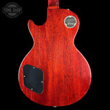 Back view of a red Gibson electric guitar on a black background