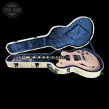 Guitar case with a guitar inside on a black background, featuring 'Tone Shop' branding.