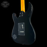 Black electric guitar with a visible brand logo on a black background